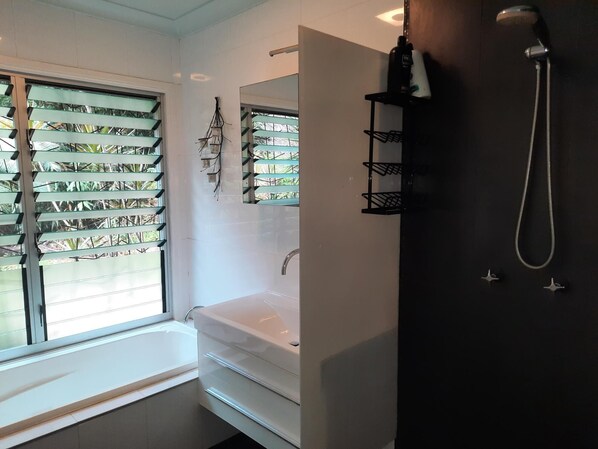 Bathtub, towels, soap, toilet paper