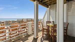 A wooden deck with outdoor seating and a view of the ocean. - The Original Lulla-by the Sea Amazing Oceanfront Beach House W/Pool and Elevator (Carolina Beach)