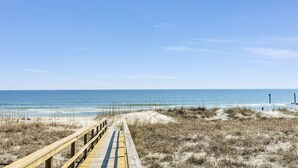 A wooden boardwalk leading to a beach with a clear sky. - The Original Lulla-by the Sea Amazing Oceanfront Beach House W/Pool and Elevator (Carolina Beach)