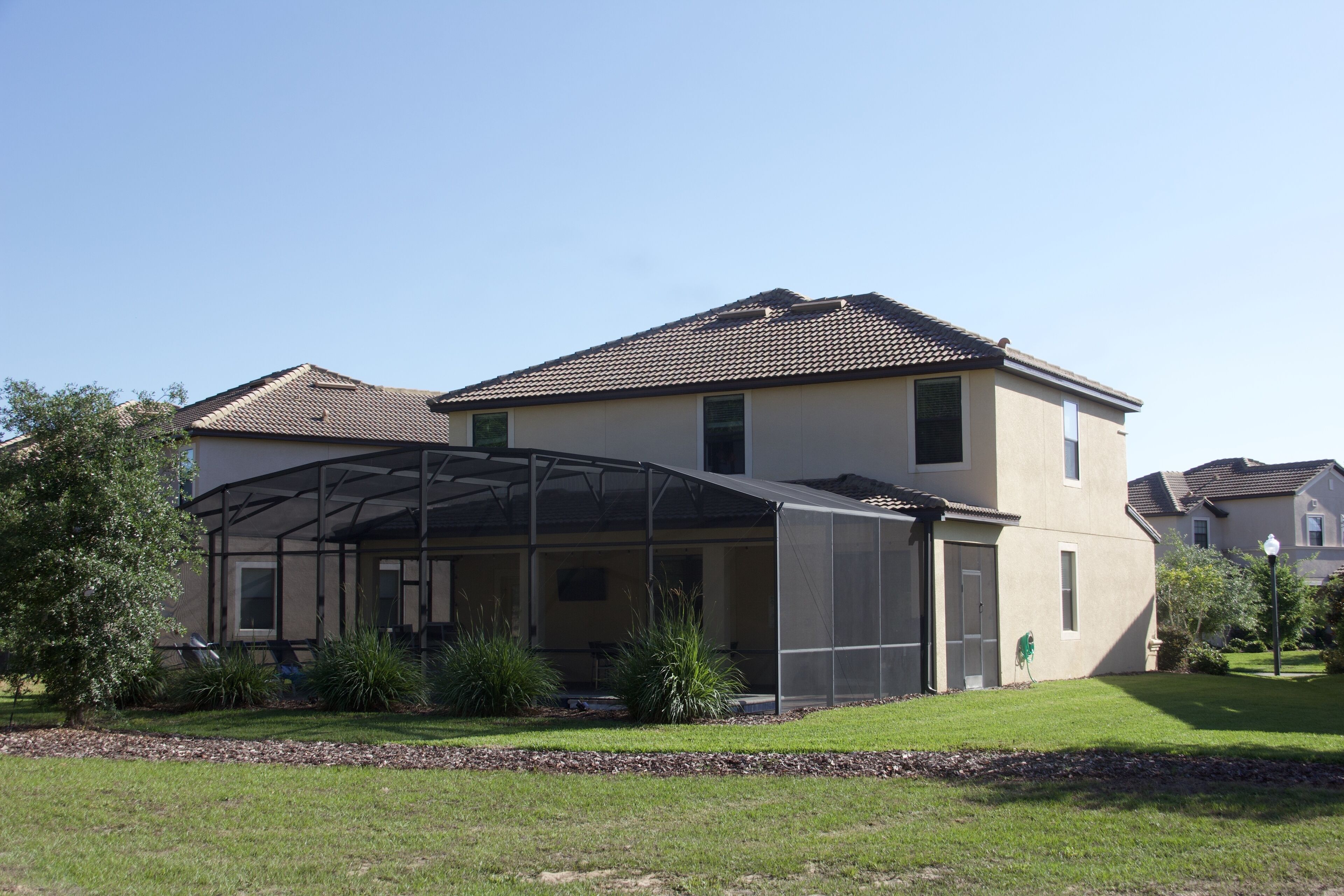 A two-story house with a covered patio area.