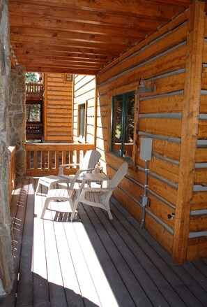 Enjoy a peaceful retreat on the porch with a comfortable seating area and a window offering a view.