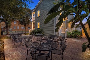 A patio with outdoor seating and a building in the background.