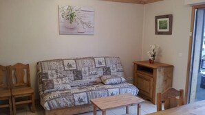 A cozy living room with a patterned sofa, wooden coffee table, and chairs. - Superb new apartment, nice and functional. Heartwarming welcome.  (Saint-Gervais-Les-Bains)