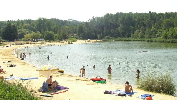 A beach with people swimming and sunbathing, surrounded by trees. - House / Villa - Mormoiron with garden and swimming pool (Mormoiron)