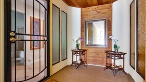 A traditional Japanese-style interior with sliding doors, a wooden ceiling, and two small tables with potted plants. - Bayfront Balcony, beach access, parking, bikes (San Diego)