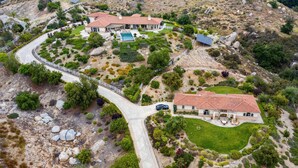 A large estate with multiple buildings, a swimming pool, and a well-maintained garden.