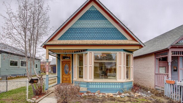 A house with a gabled roof, a front porch, and a mailbox.