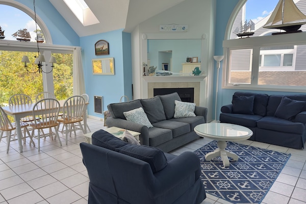 Living/dining room with view of 9th hole. Skylights. So bright and attractive