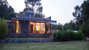 A modern house with large glass windows, a covered porch, and a well-maintained lawn. - BRIGHT 250m² ARCHITECT-DESIGNED VILLA OPEN TO THE OUTDOORS WITH PRIVATE POOL (Messanges)