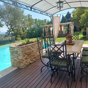 A covered outdoor patio with a pool, stone wall, and outdoor furniture. - Tuscan villa pool spa Siena Montepulciano Perugia Pienza Florence 2 hours from Rome (Cetona)