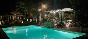A swimming pool with a covered seating area and stone walls. - Tuscan villa pool spa Siena Montepulciano Perugia Pienza Florence 2 hours from Rome (Cetona)