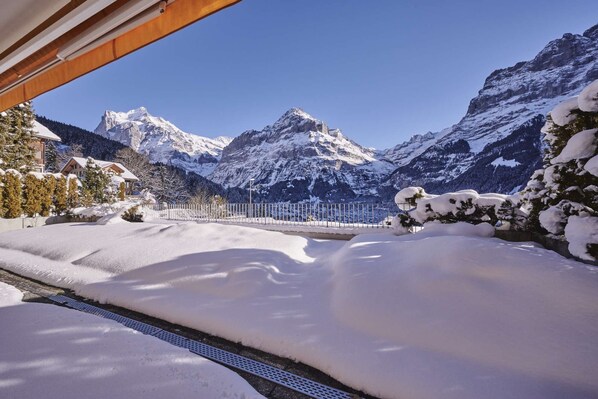 A snow-covered mountain landscape with a clear sky.
