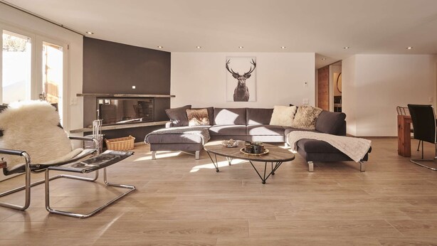 A modern living room with a sofa set, a coffee table, and a fireplace.
