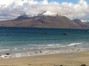 A beach with a mountain in the background.