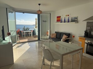 Un espace de vie moderne comprenant un coin repas, un canapé et une cuisine.
