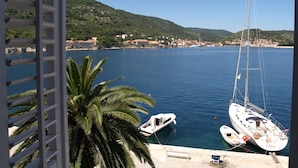 A marina with boats docked, a clear sky, and a hilly landscape in the background. - Luxury seafront villa, stunning sea & harbour views, on unspoilt island of Vis (Vis)