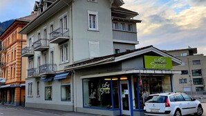 A multi-story building with a cafe named 'Easy Style' on the ground floor.
