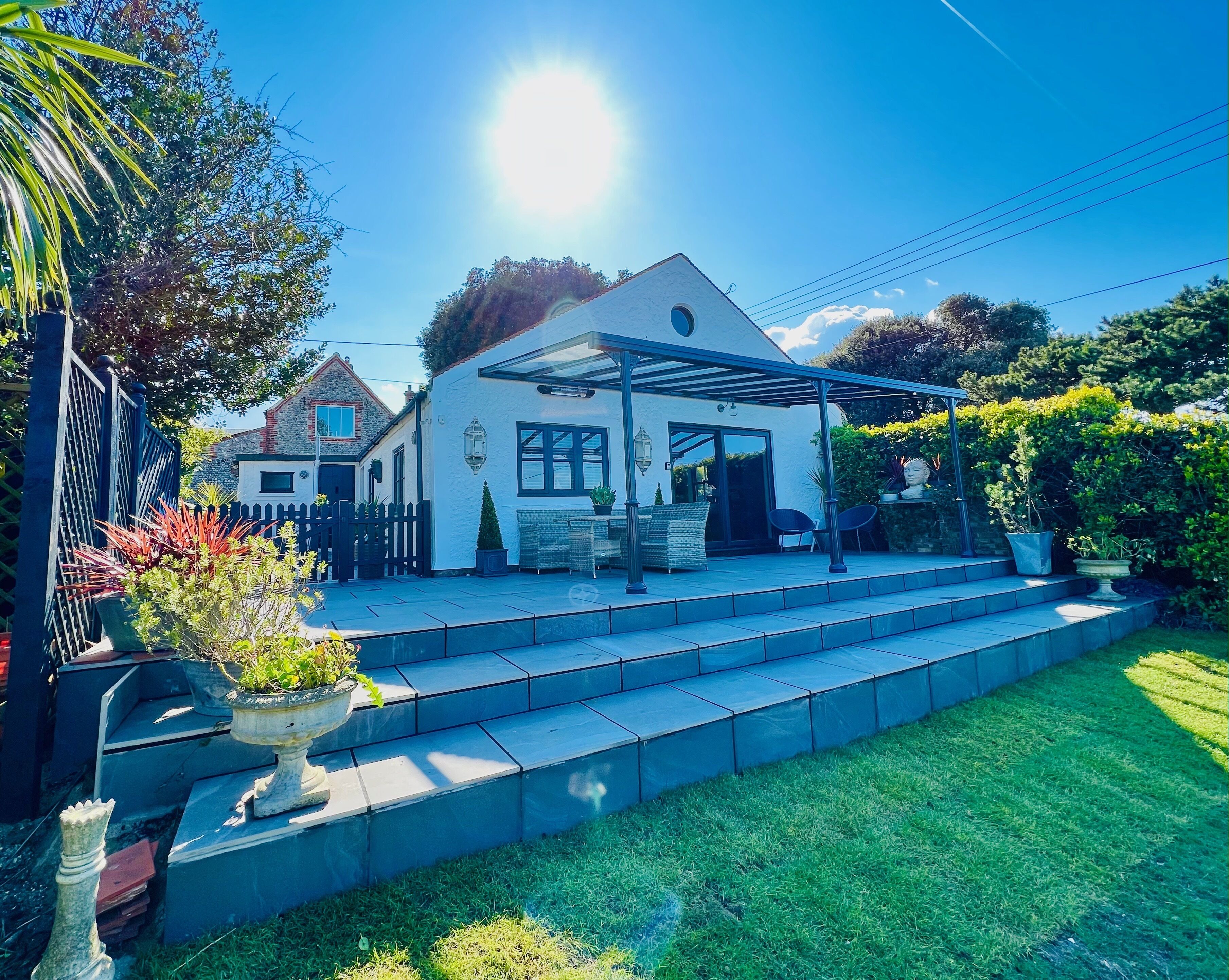 2022 – New veranda and terrace steps down to large lawned garden 