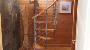 A spiral staircase in a wooden interior with a broom leaning against the wall. - The Palms - Spacious Private Villa For Family  Fun & Relaxation (L'Ametlla de Mar)