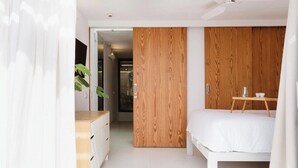 A bedroom with a wooden wardrobe, a bedside table with a cup, and a plant. - Hot pool, sea, wifi pro, gas barbecue, garden, 09 (San Miguel de Abona)