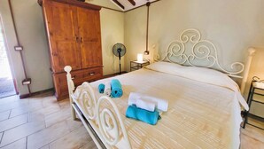 A bedroom with a bed, wooden wardrobe, and a fan. - Totally private cottage with own pool, amazing views and close to Barga!  WIFI (Barga)