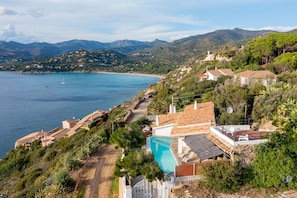 Enjoy a serene hillside retreat with a pool and breathtaking views of the coastal landscape.