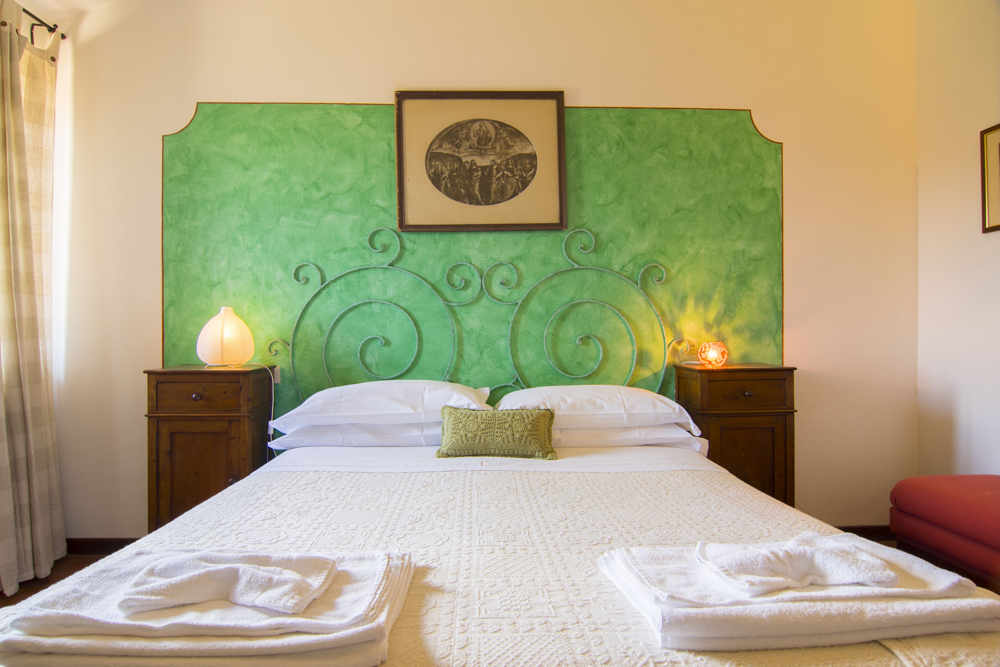 A farmhouse nestled among gardens and olive trees