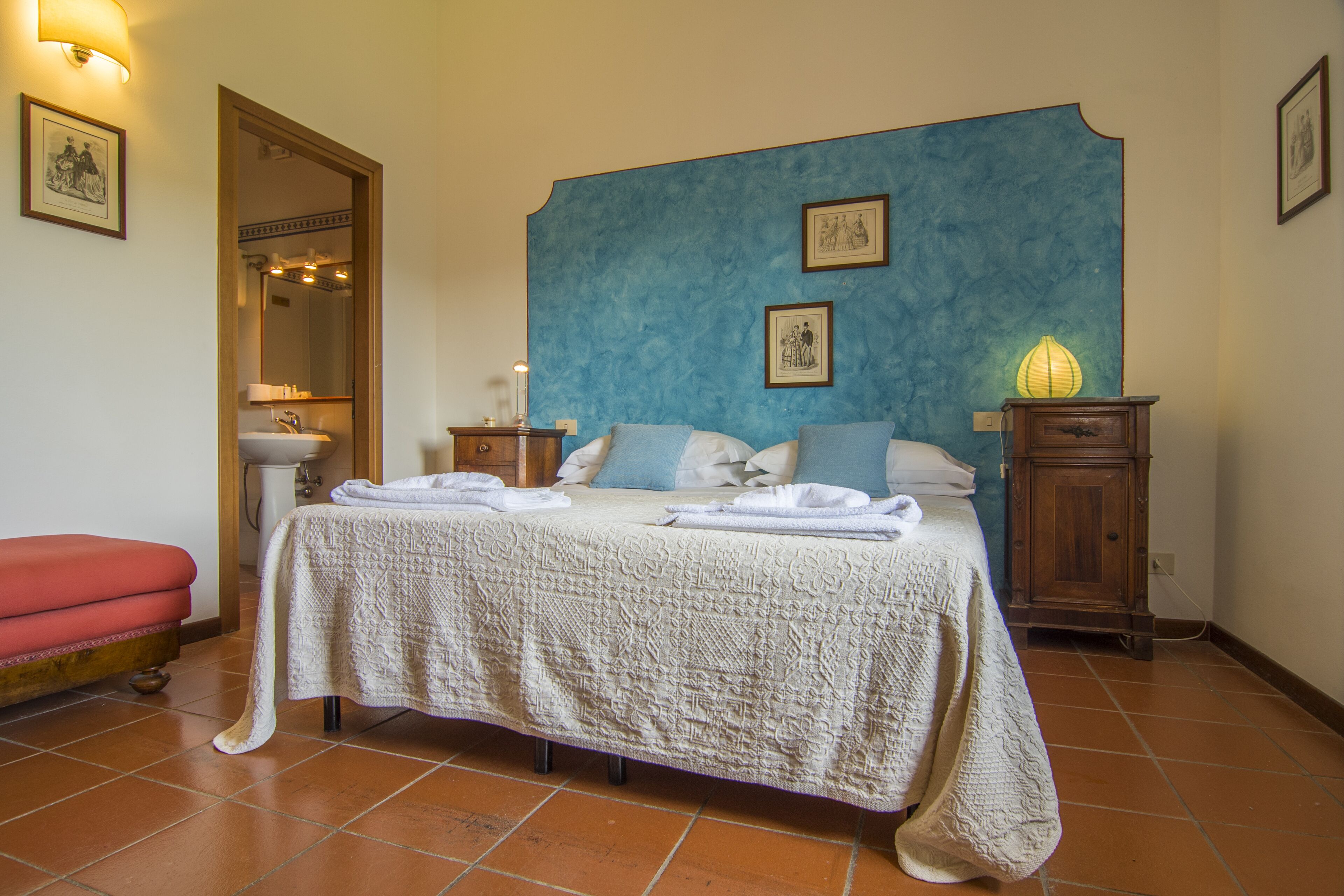 A farmhouse nestled among gardens and olive trees