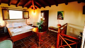 A cozy room with a bed, a round wooden table, and a chair. - Otranto: SPLENDID TENUTA WITH POOL AND TENNIS COURSE. (Muro Leccese)