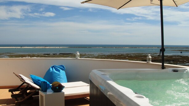 A hot tub with a view of the beach and ocean. - Top Apt With Roof Terrace, Stunning 180º Atlantic Ocean and Ria Formosa View! (Fuseta)