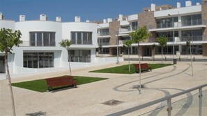 A modern building with a courtyard, benches, and trees. - Top Apt With Roof Terrace, Stunning 180º Atlantic Ocean and Ria Formosa View! (Fuseta)