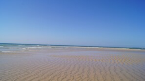 A beach with a wide sandy area and gentle waves. - Top Apt With Roof Terrace, Stunning 180º Atlantic Ocean and Ria Formosa View! (Fuseta)