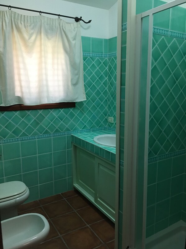 A bathroom with a toilet, bidet, and sink. - BEAUTIFUL HOUSE. FANTASTIC PANORAMA. DREAM ATMOSPHERE. (Porto San Paolo)