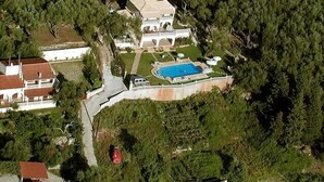 An aerial view of a large estate with a swimming pool, multiple buildings, and surrounding greenery. - Private Villa with superb seaview, swimming pool, garden, parking, pet friendly (Corfu)