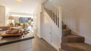 A kitchen with a wooden countertop, a loaf of bread, and a jar of jam. - Driftwood Cottage, Brancaster, Norfolk (King's Lynn)