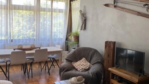 A modern living room with a sofa, TV stand, and dining area. - Apartment/ flat - Canillo (canillo)