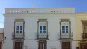 A white building with three wooden doors and windows, each with a balcony. - River view apartment in historical centre of Tavira with roof terrace & WiFi  (Tavira)