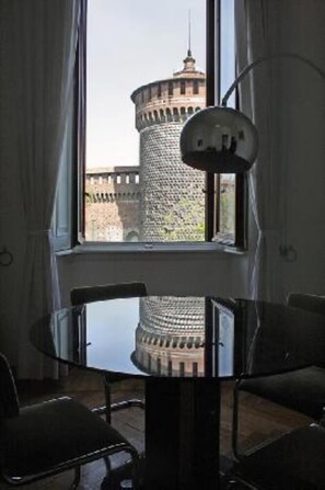 Enjoy a view of the historic landmark from the comfort of this room, where a round table and two chairs face a large window.