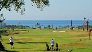 A golf course with a view of the ocean.