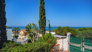 A coastal view with a clear sky, a tall cypress tree, and a building with a red roof. - House / Villa - Sciacca (Sciacca)