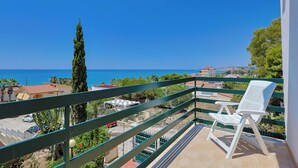 A balcony with a white chair, overlooking a coastal area with houses and greenery. - House / Villa - Sciacca (Sciacca)