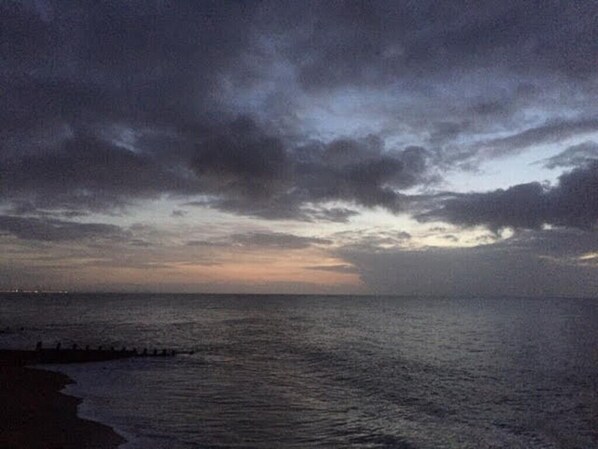 A beach scene with a cloudy sky and calm sea. - Charming Seaside Home, Full of Character (Old railway carriages) Pet Friendly, (Chichester)