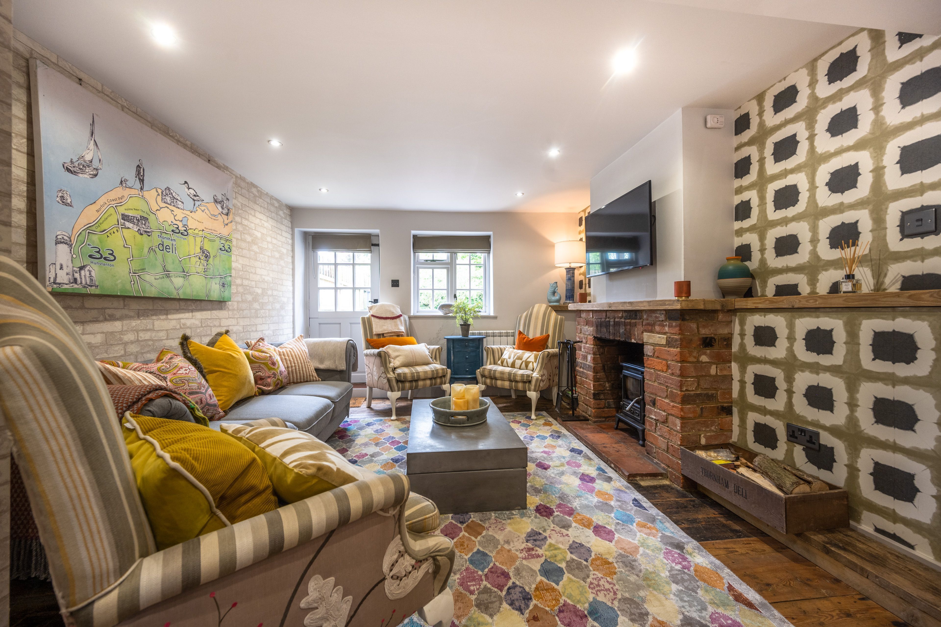 No. 33 Cottage 4, Thornham: Sitting room with wood burning stove