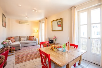 Bright open living area leading onto sunny balcony.