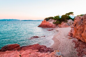 Una playa costera con formaciones rocosas y una vista despejada del mar.