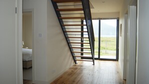Un intérieur moderne avec un escalier en bois menant à un balcon.