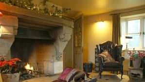 A cozy living room with a fireplace, a leather armchair, and a sofa. - Sleeps 16,, Indoor Heated Pool, Rooftop Hot Tub, Devon Coast Views, Pets welcome (Honiton)