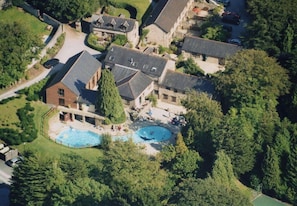 A residential area with multiple houses, a swimming pool, and a tennis court.