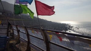 A coastal view with flags on a railing. - Edwardian House in the Heart of Weymouth 200m from Sandy Beach by the Sea (Weymouth)