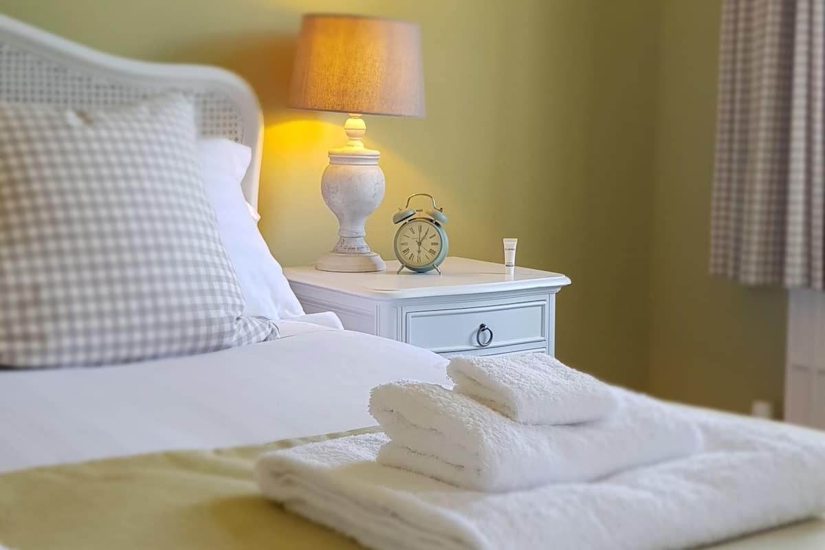 Premium bedding, desk, laptop workspace, blackout curtains